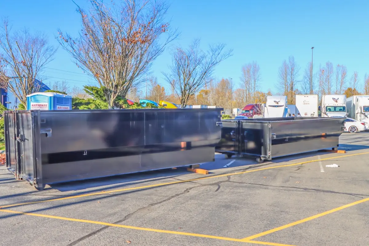 Professional dumpster rental service with roll-off container on residential driveway in Castaic